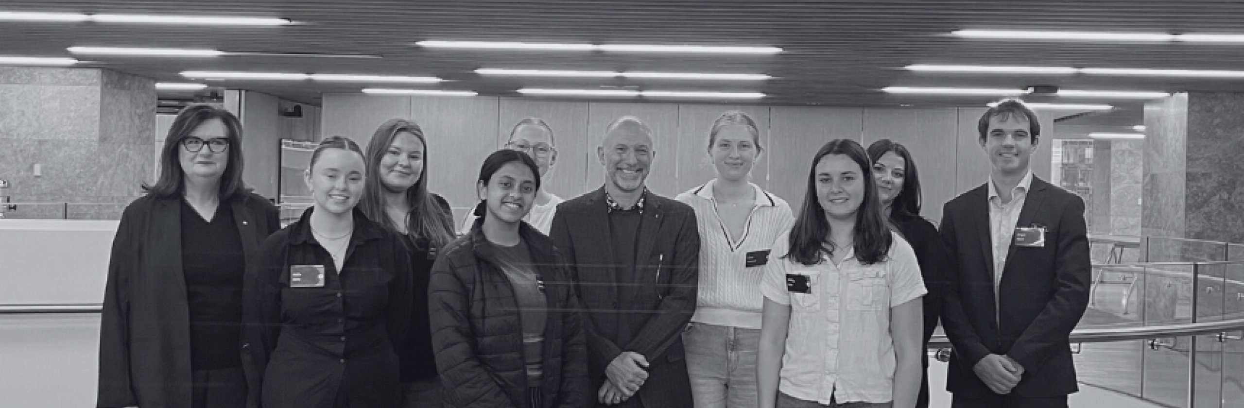 Black and white images scholars facing camera.