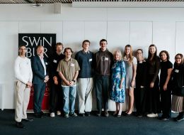 People lined up smiling at camera.